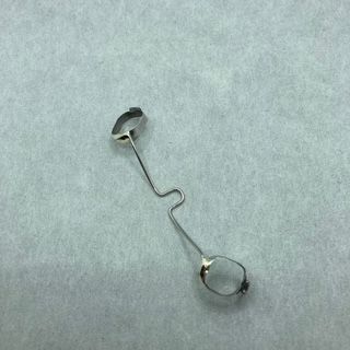 A close up of a metal object on a white surface.