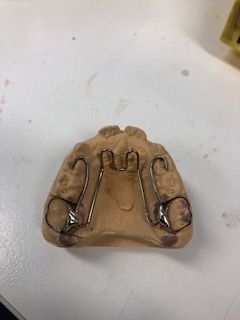 A dental appliance is sitting on top of a white table.