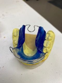 A close up of a dental appliance on a table.