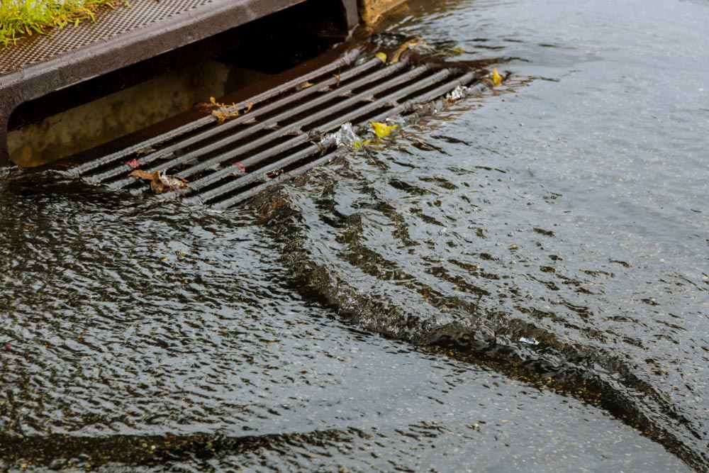 Water Pouring In Stormwater Drain — Plumbing And Gasfitting In Boat Harbour, NSW