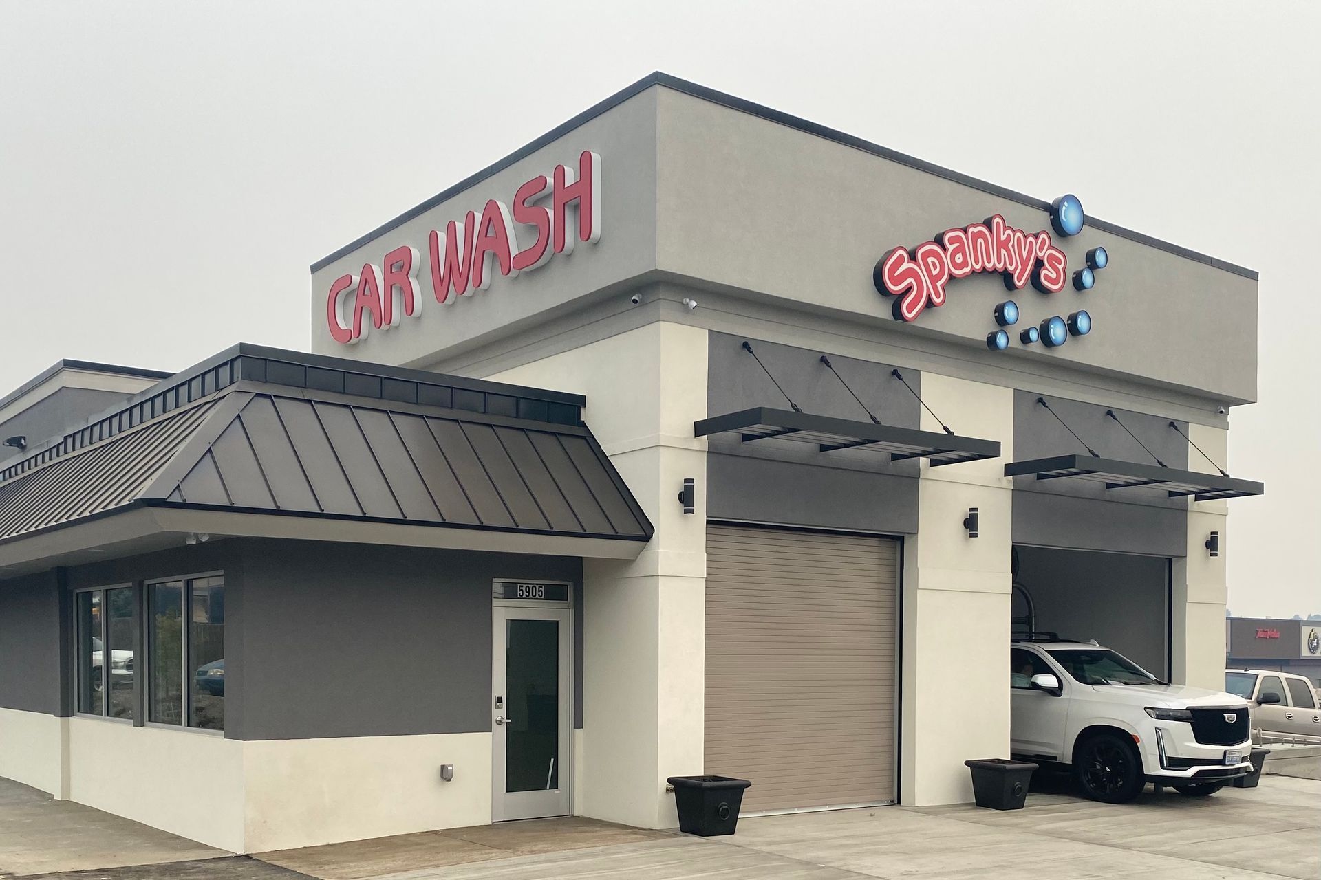 A car is parked in front of a car wash.