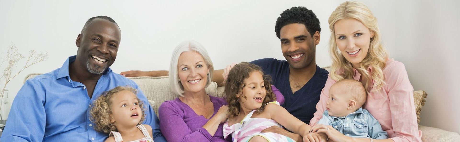 Portrait of happy multi-generation family sitting on sofa at home