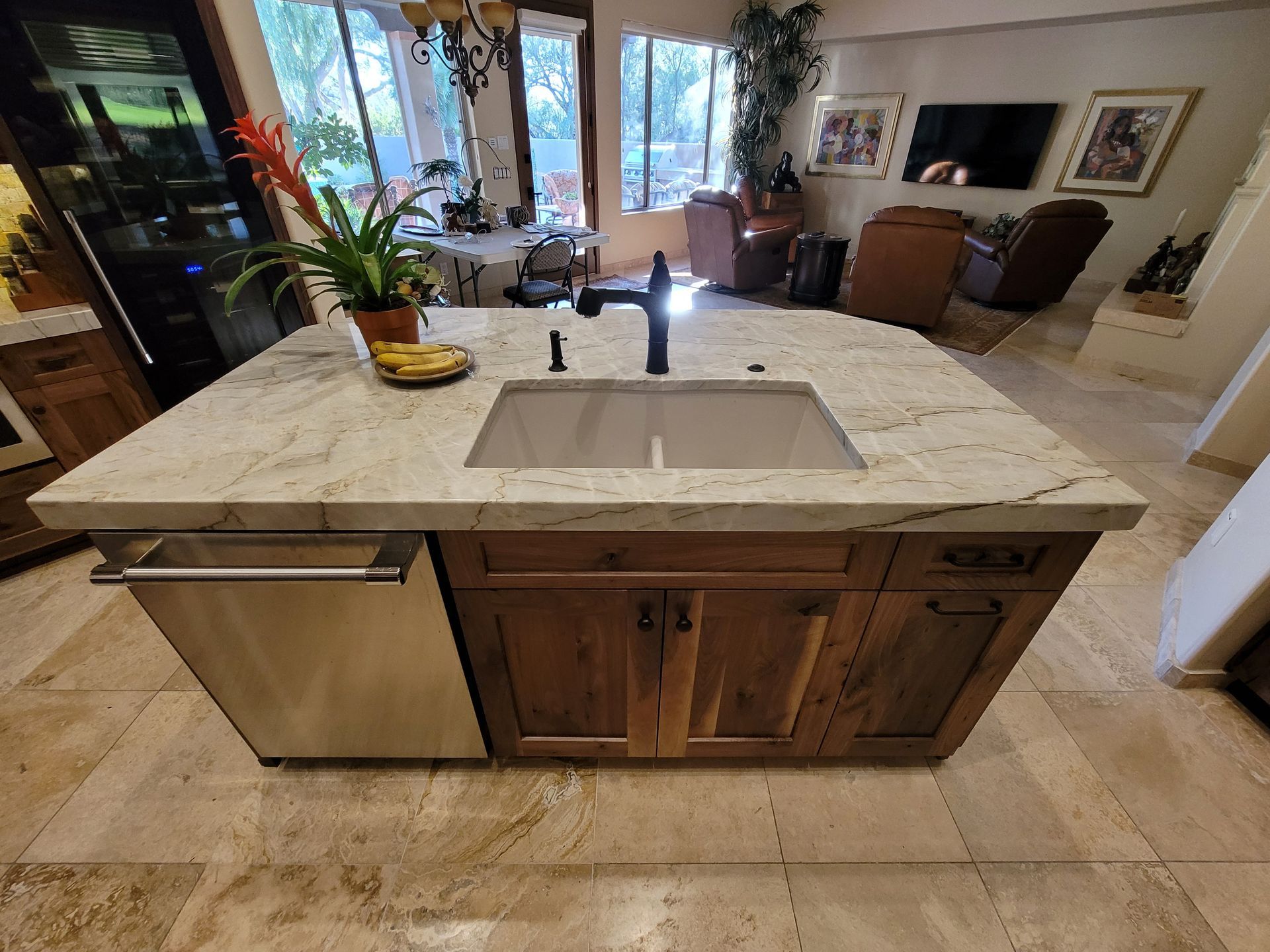 Modern kitchen remodel in [Tucson, AZ] featuring cabinets, waterfall quartz countertops with gold veins, stainless steel appliances ( pot filler faucet, refrigerator, wood accent breakfast bar.