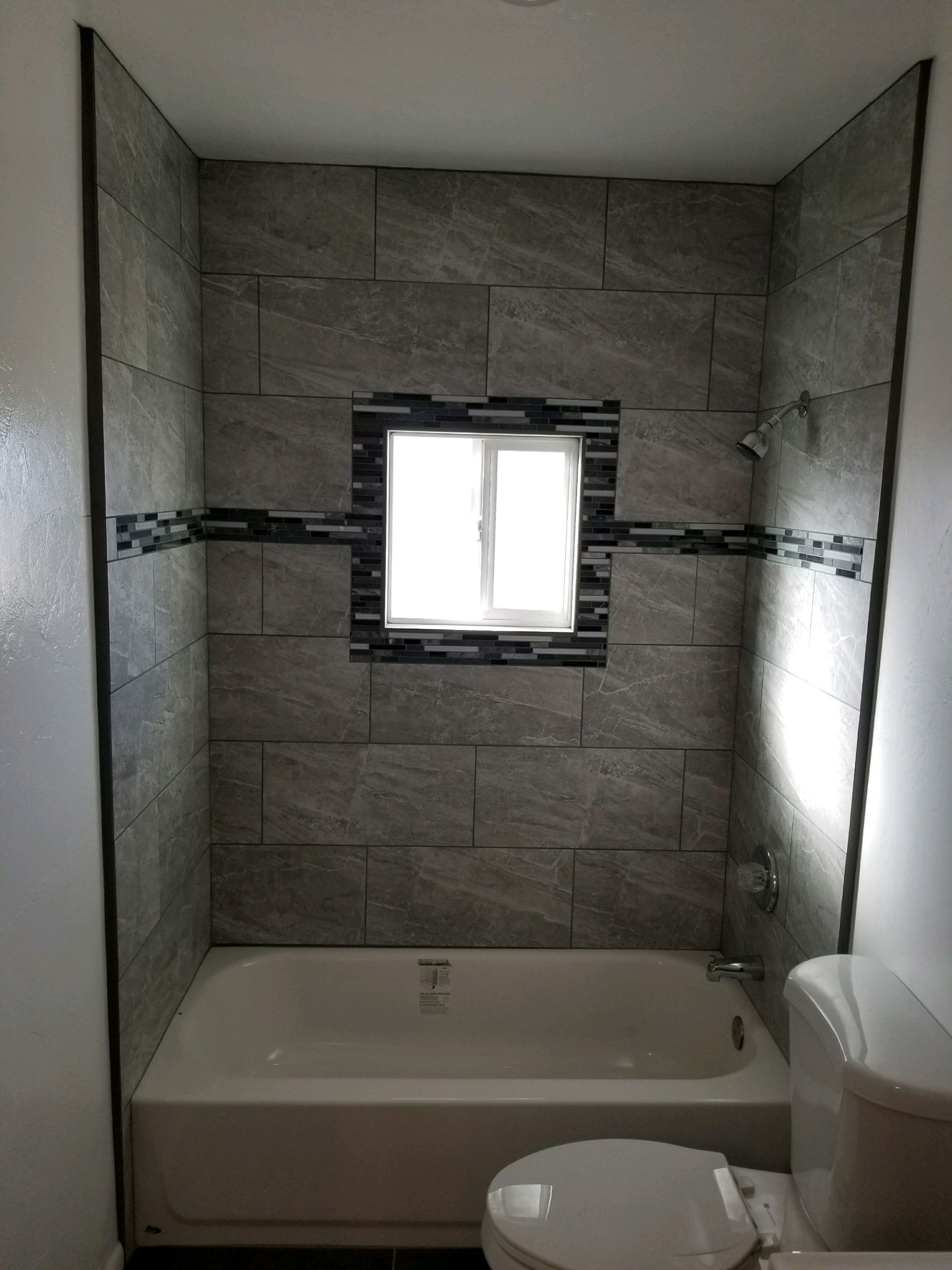 Bathroom shower with gray tiles