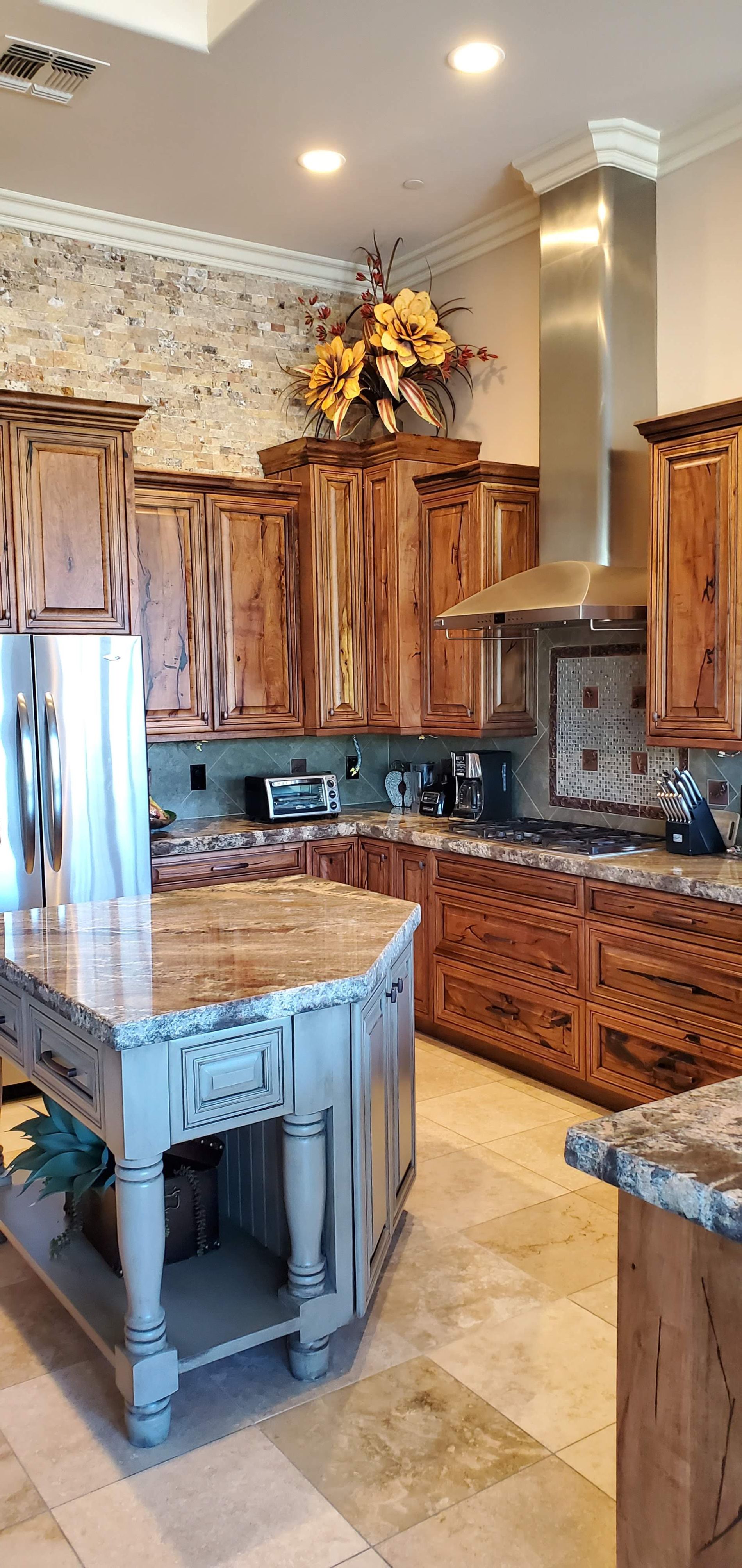 Kitchen with wood cabinets and marble counters