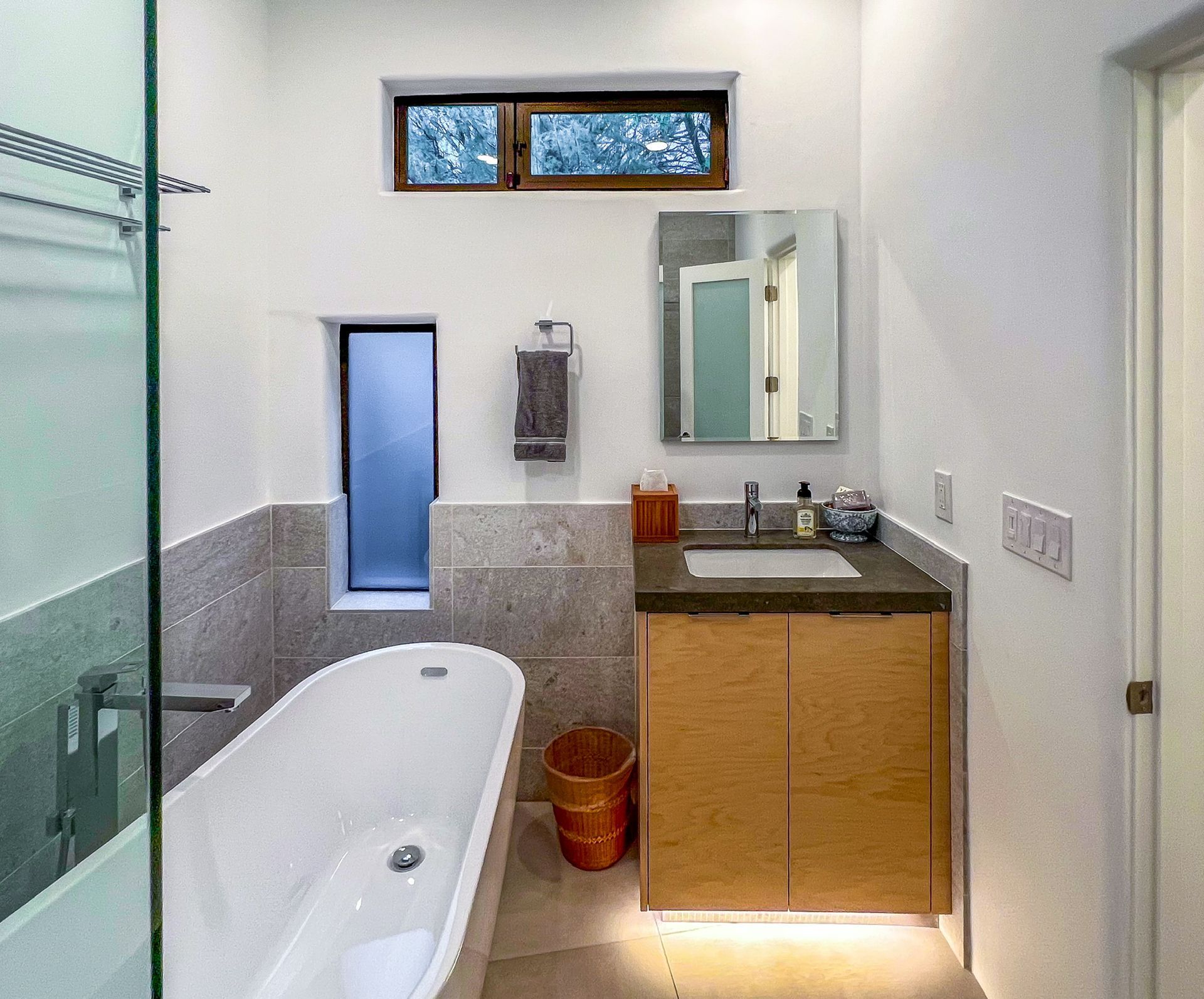 A vanity with a sink and a walk-in shower.