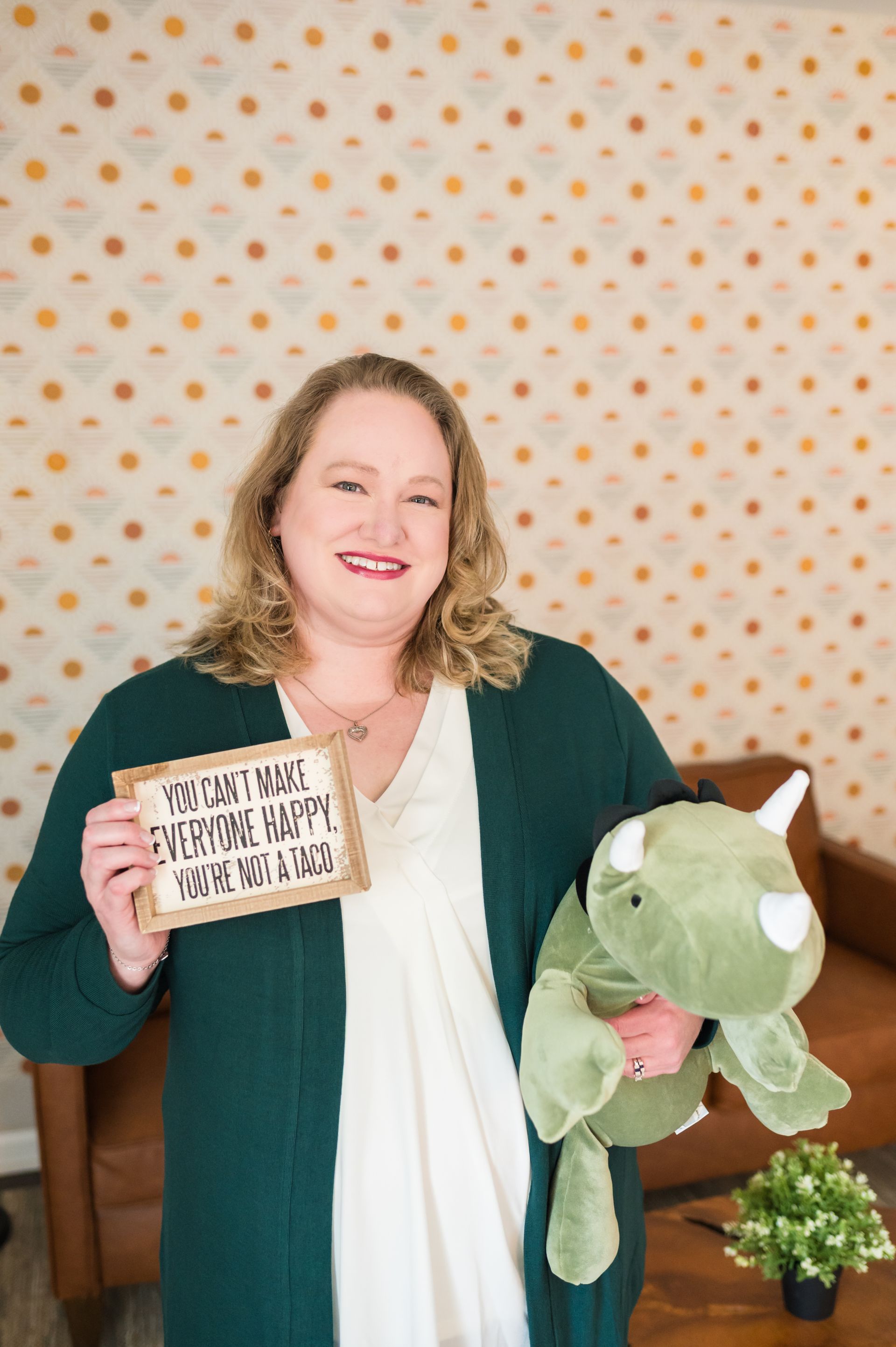 Woman smiling, holding sign 