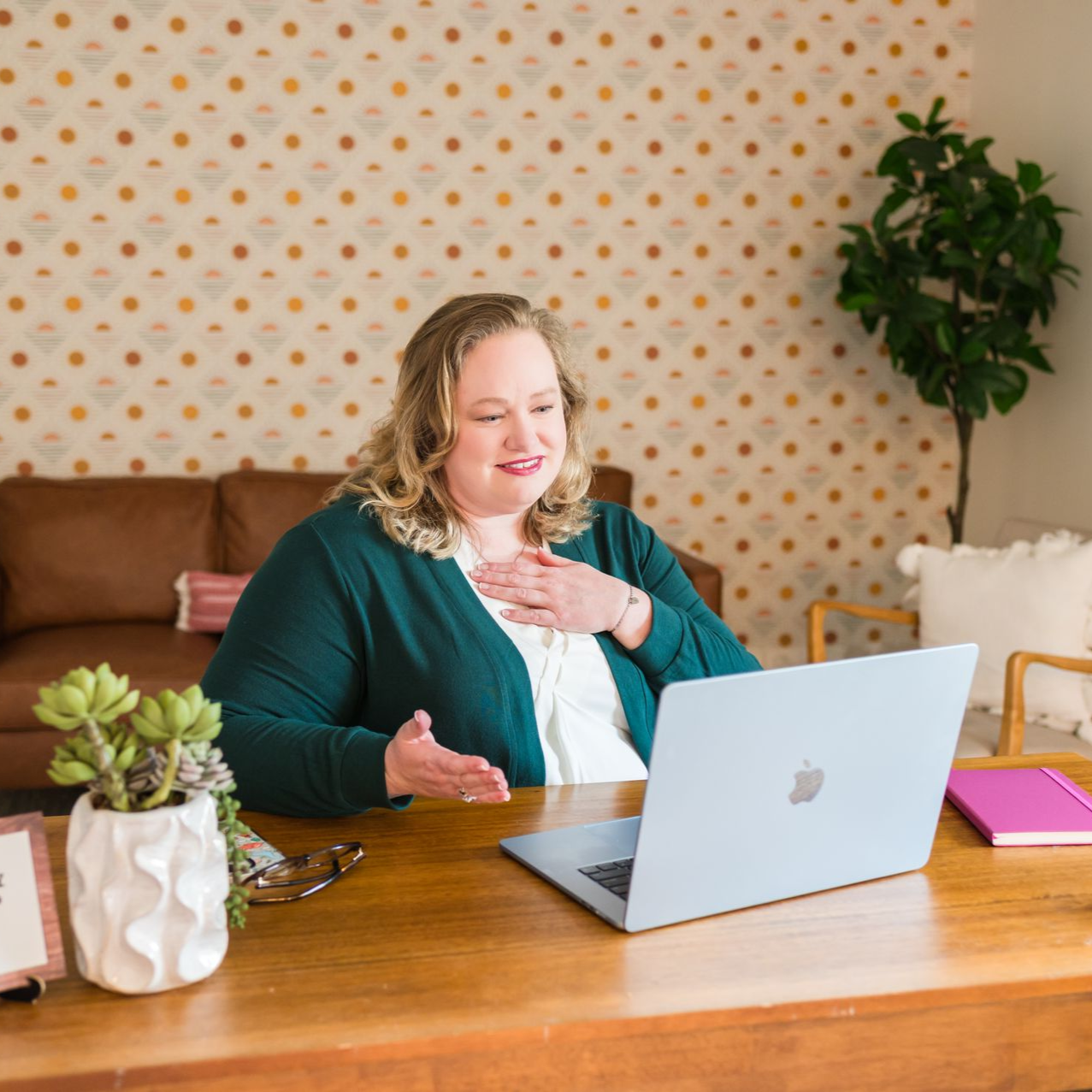 Desk with a laptop, books, and banner that says