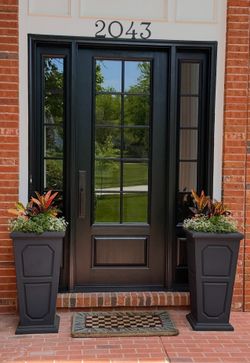 Black front door with sidelights, address