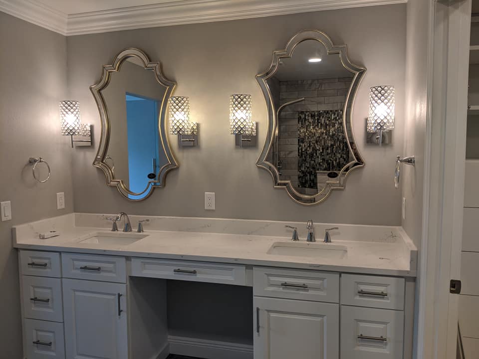 A bathroom with two sinks and two mirrors.