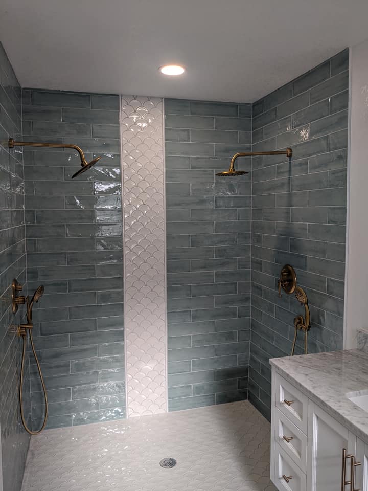 A bathroom with two showers and a sink.