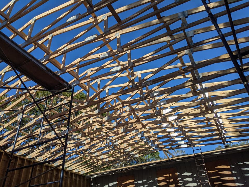 The ceiling of a building under construction with a blue sky in the background