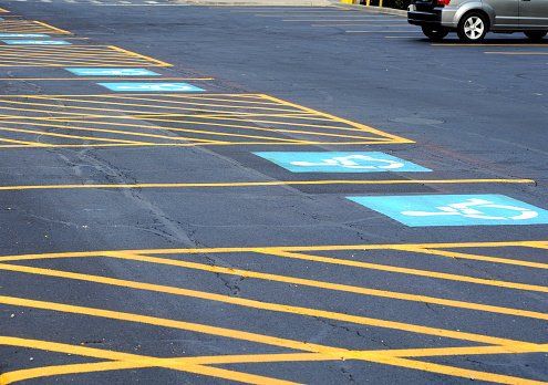 A parking lot with freshly painted striping and PWD markings.