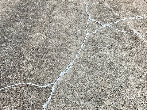 Layer of bonding adhesive applied to a cracked concrete surface.
