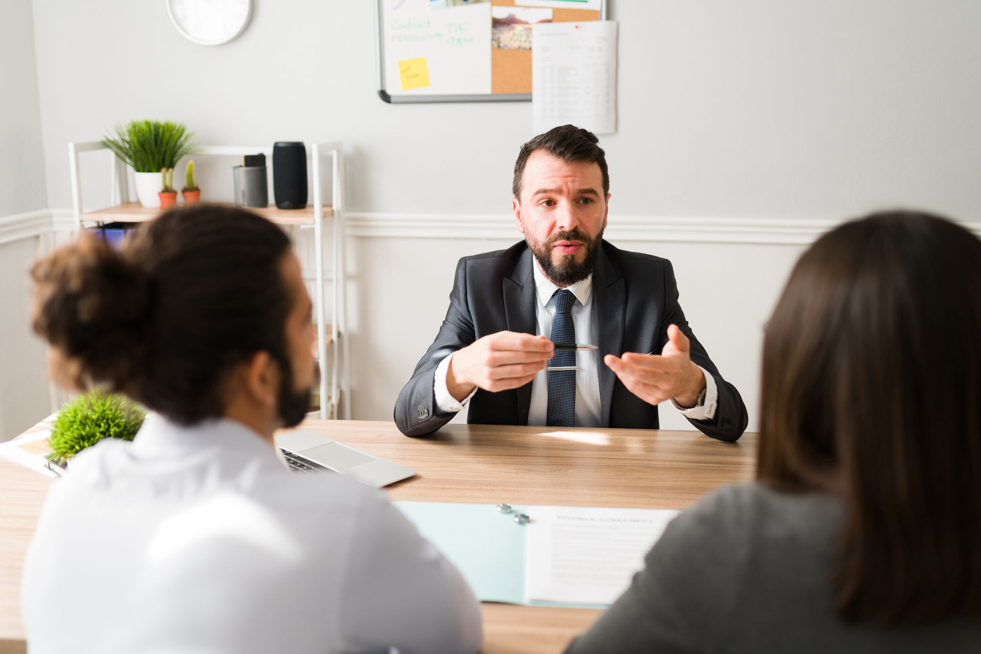 A divorce attorney explaining the legal procedure to a couple.