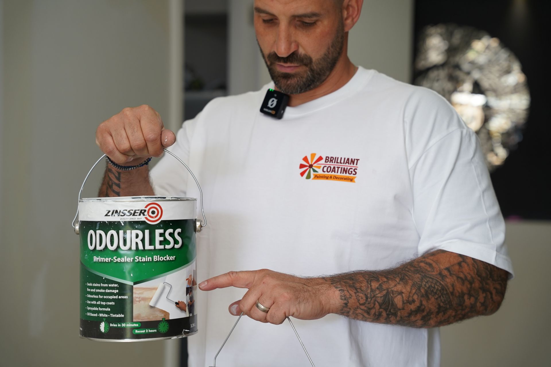 Man holding and pointing at a can of 