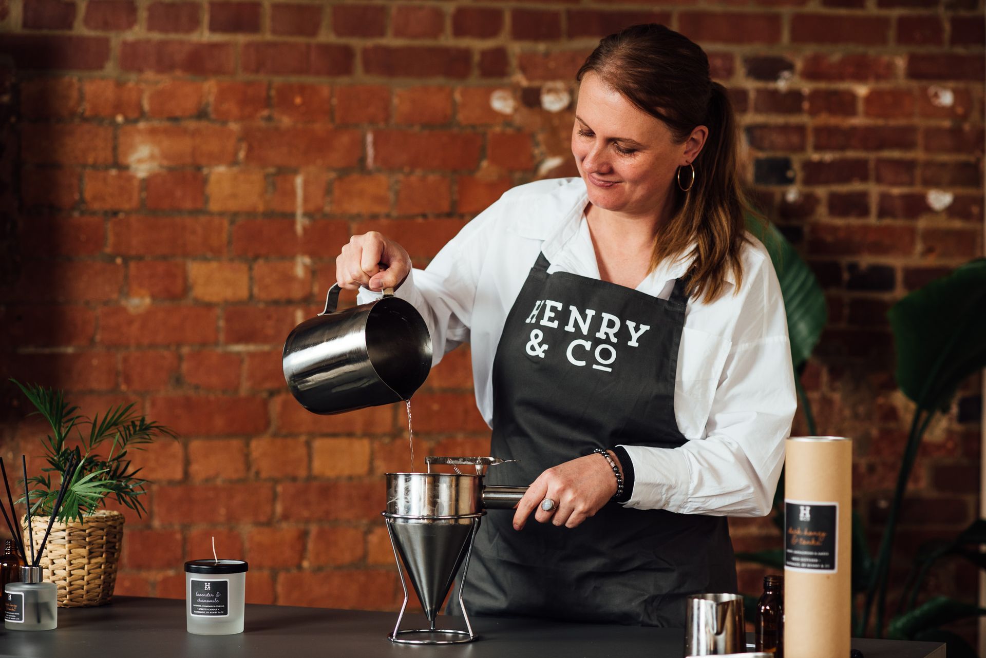 Jo the Master Chandler of Henry & Co pouring wax into a mould.
