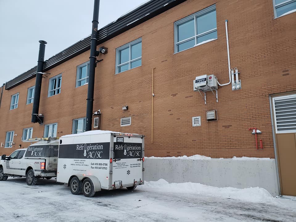 Un immeuble avec une caravane garée devant