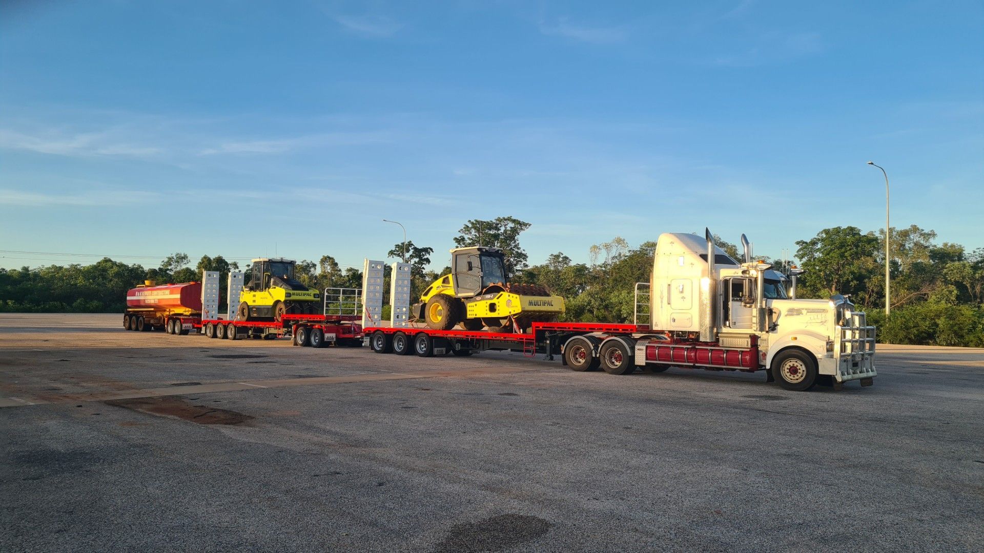 Yellow road roller in an outdoor setting.