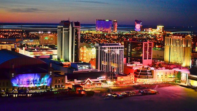 An aerial view of atlantic city, new jersey at night with many casinos lit up