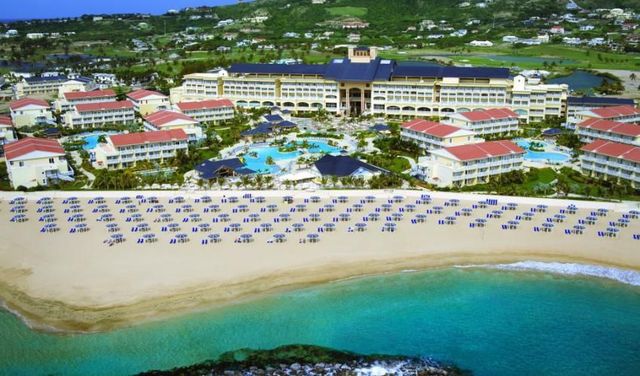 An aerial view of st. kitts marriott beach resort with lots of umbrellas