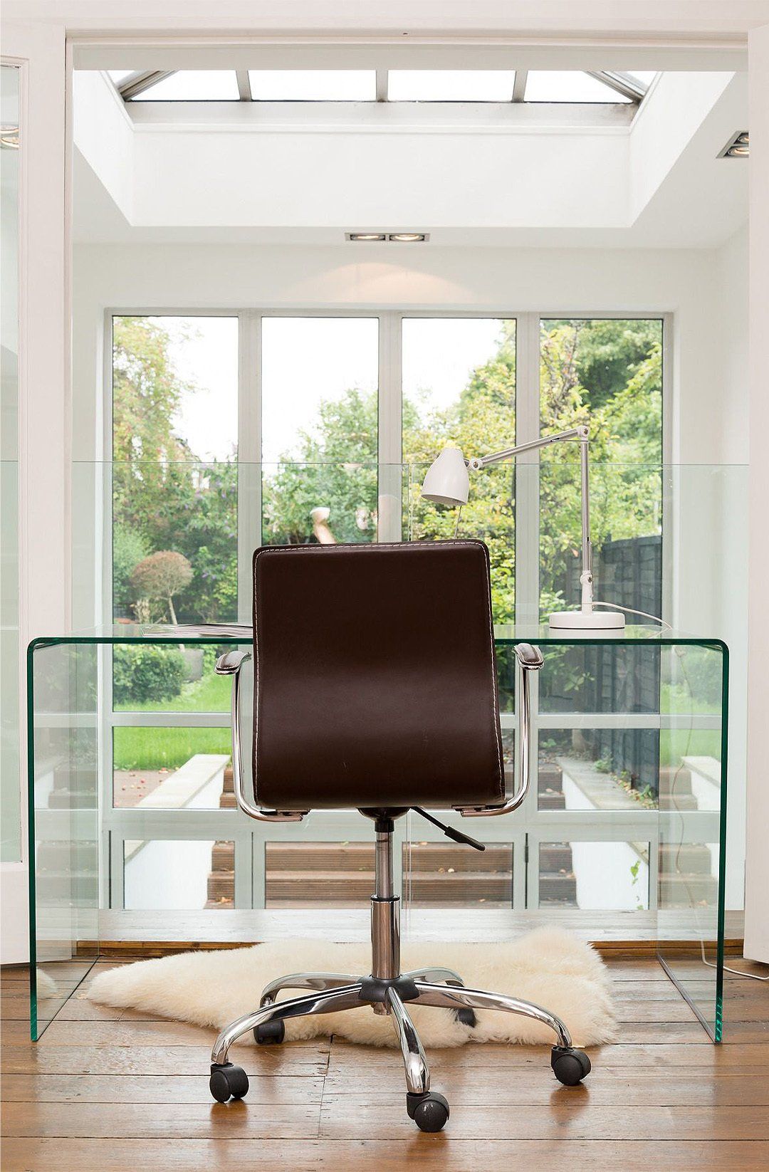 Leather office chair and glass desk interior design