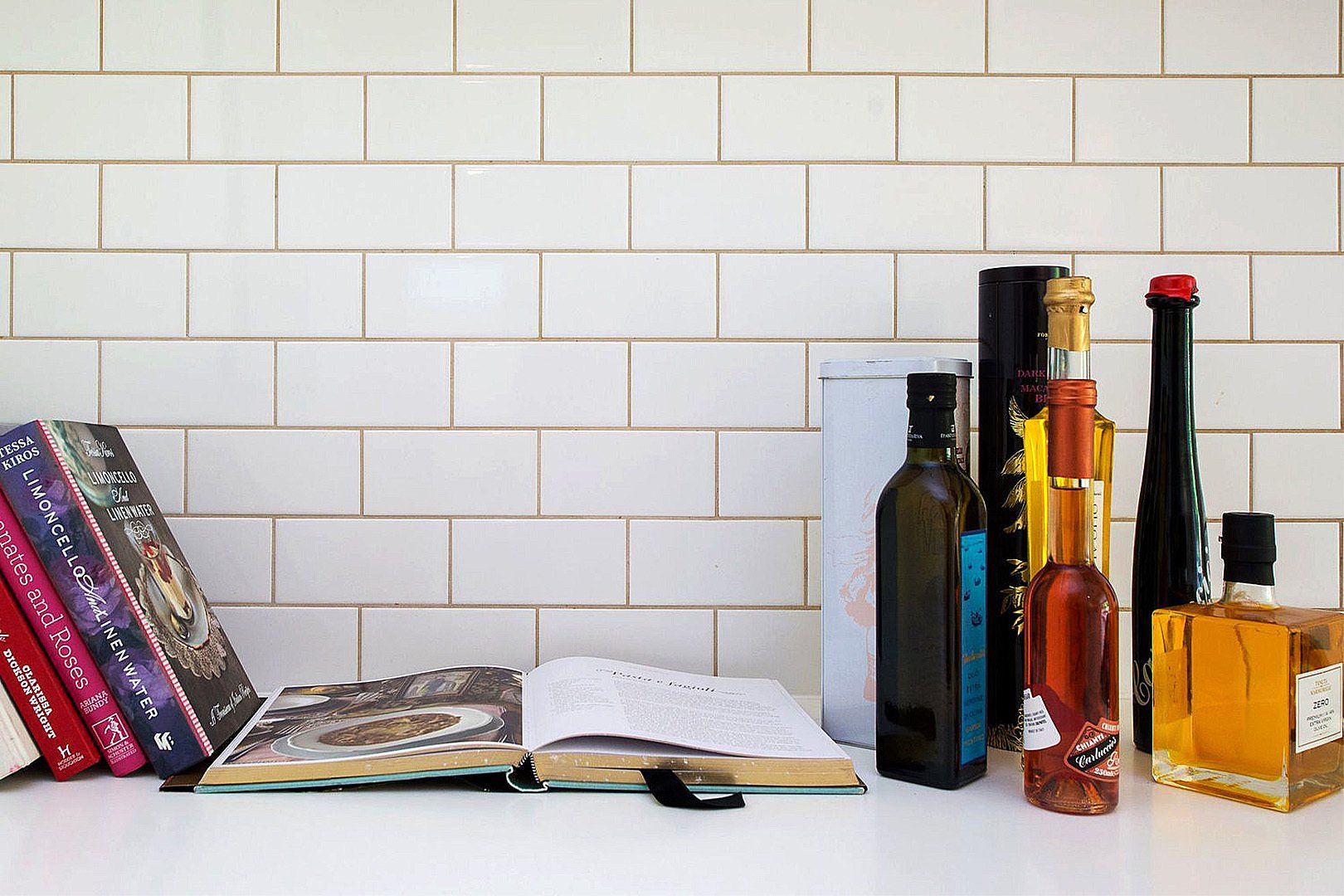 Cook books, wine bottles and olive bottle closeup interior design