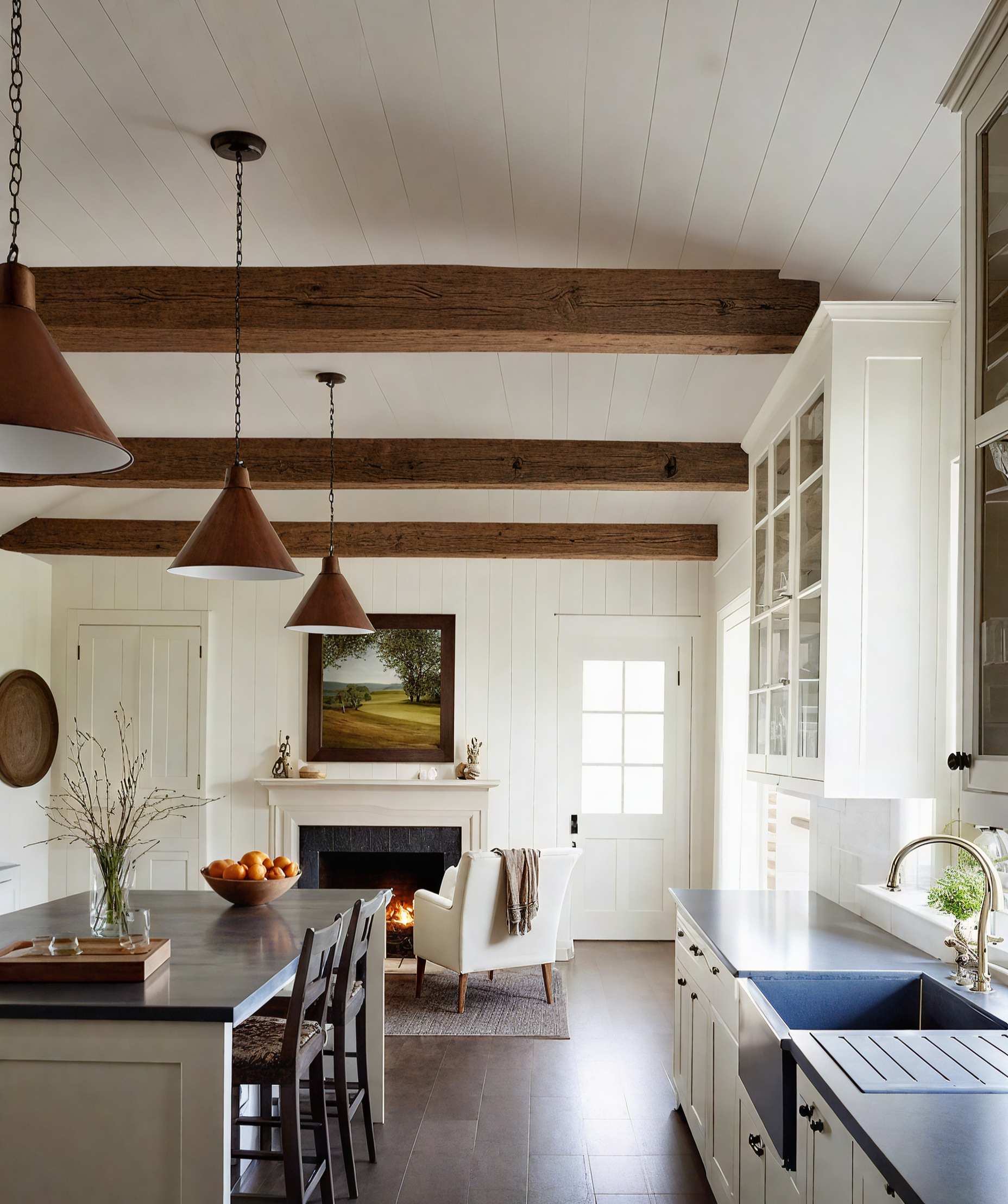 A kitchen with white cabinets, a sink, a table and chairs.