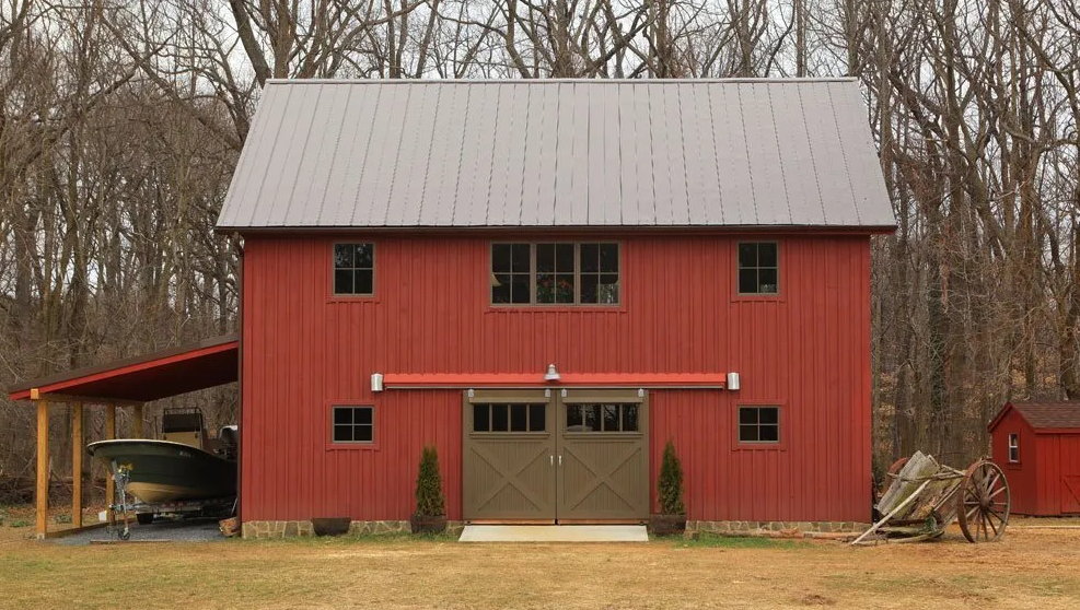 A living room with a couch, chair, television and speakers.