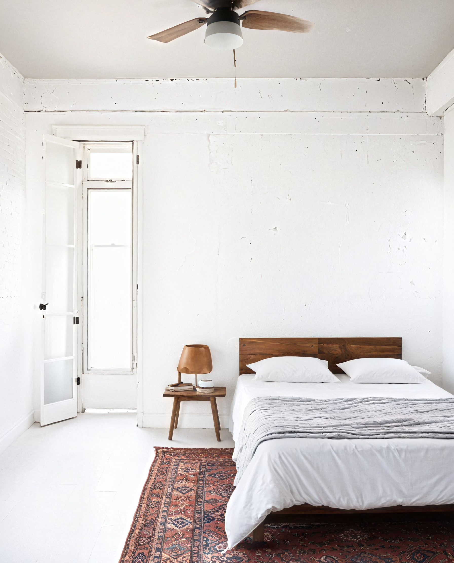 A living room with a couch, table, chairs and a wall filled with pictures.