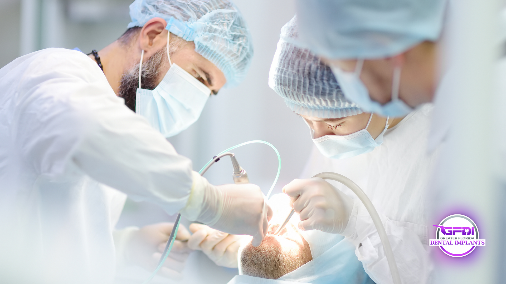 Surgeons in surgical gowns and masks performing an operation on a patient in an operating room.