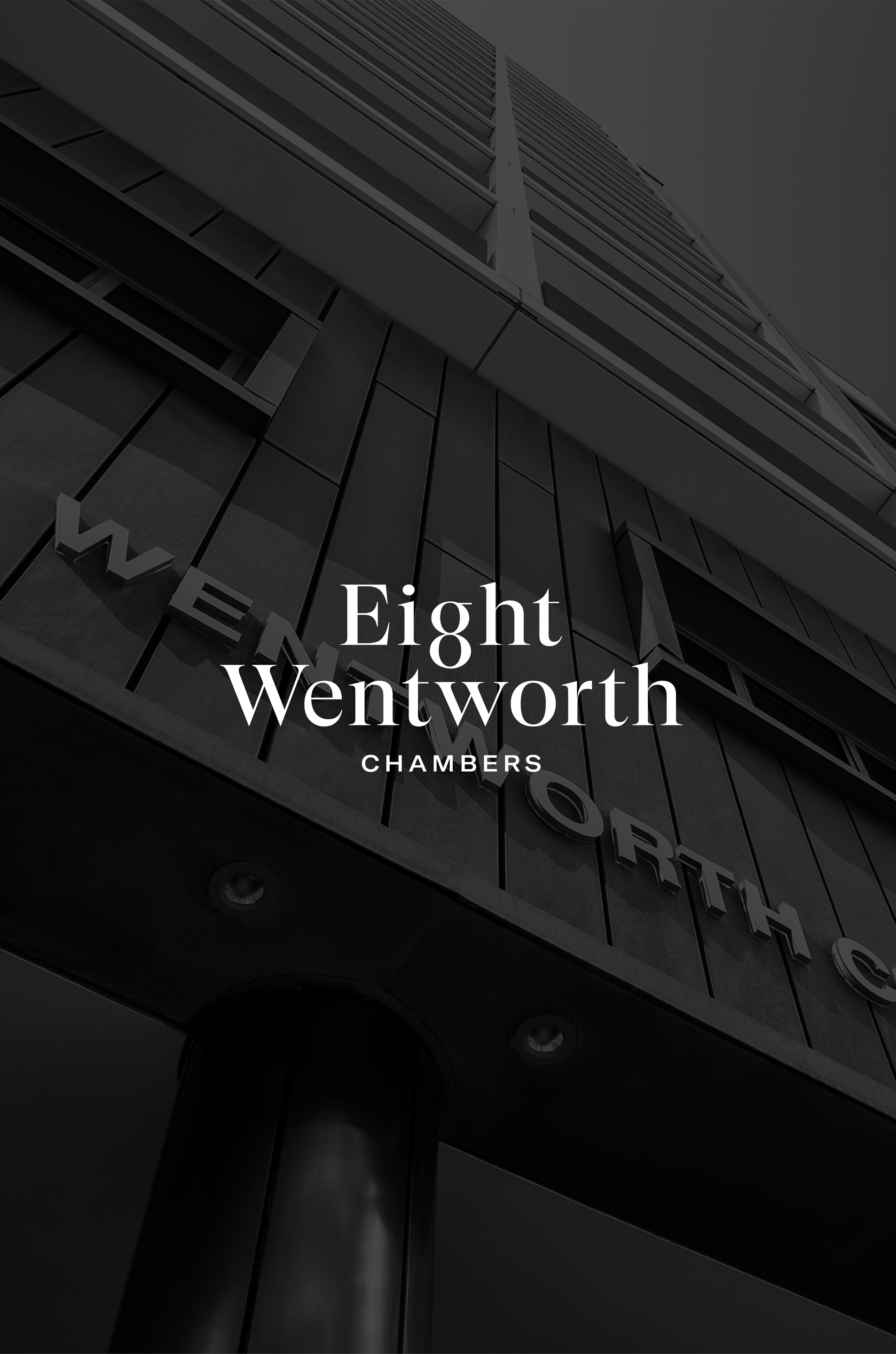 A black and white photo of a building with the words eight wentworth written on it.