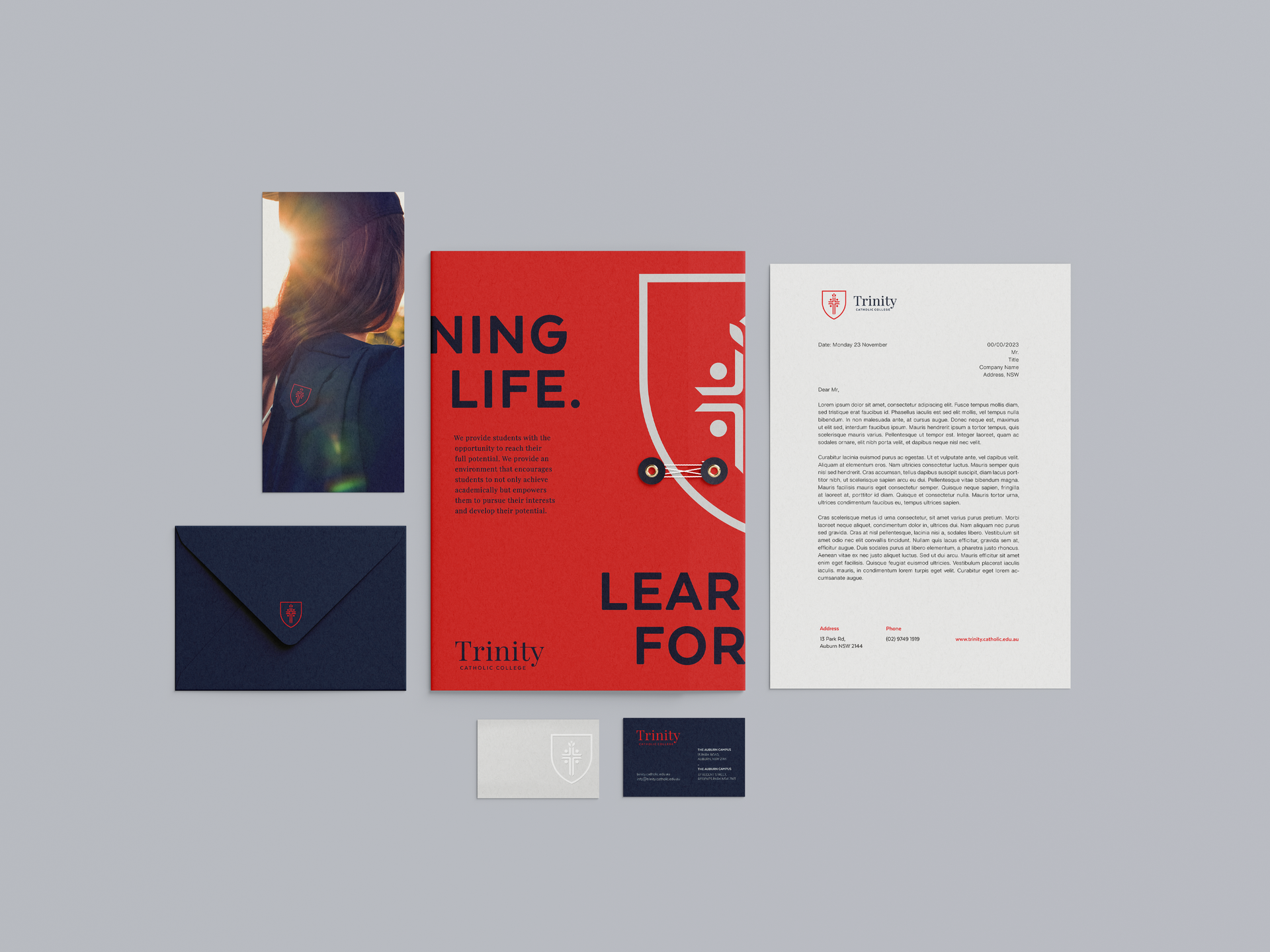 a set of business cards , envelopes , flyers , and a letter on a table .