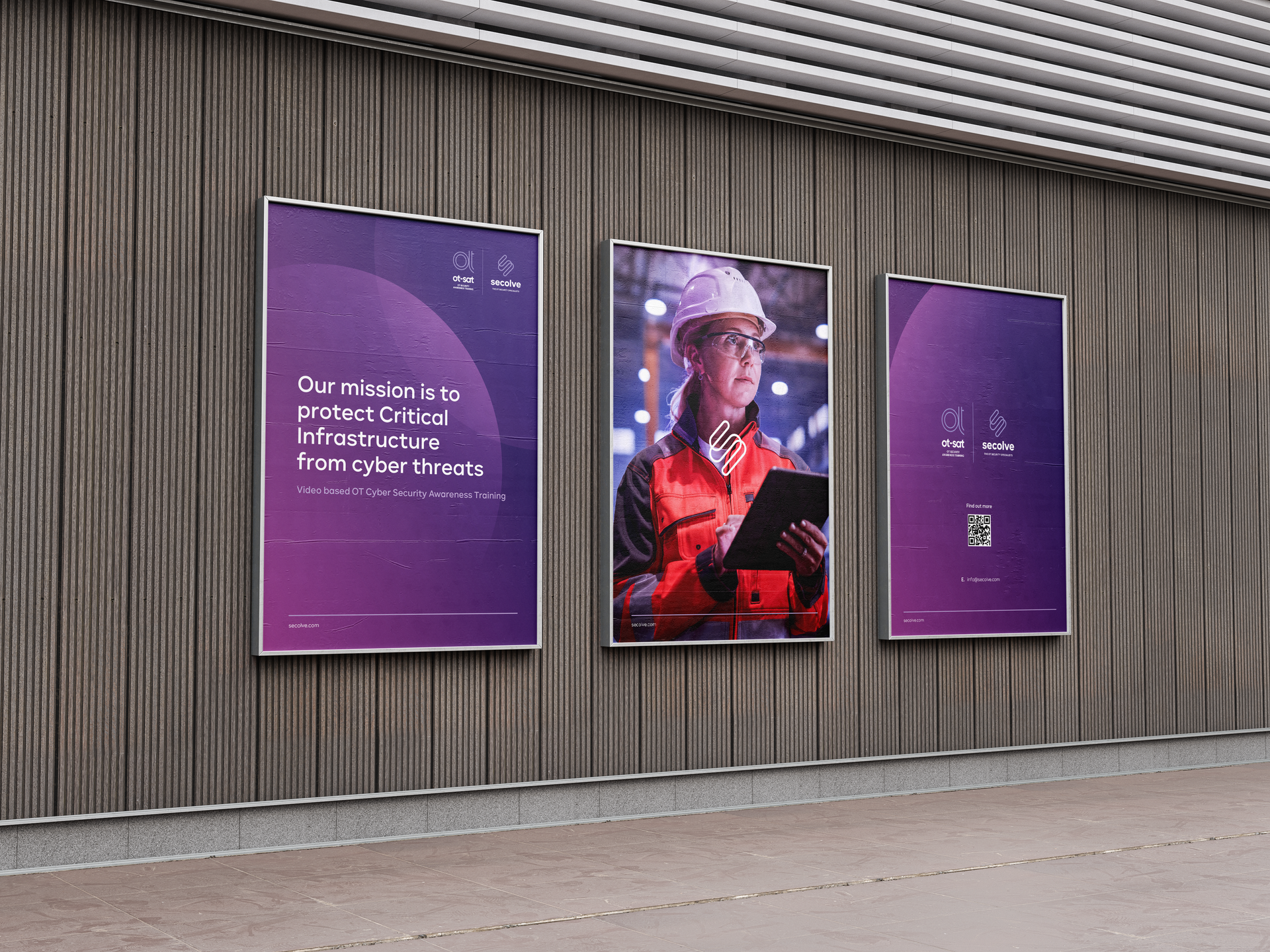 three posters are hanging on a wall with a man in a hard hat holding a tablet .