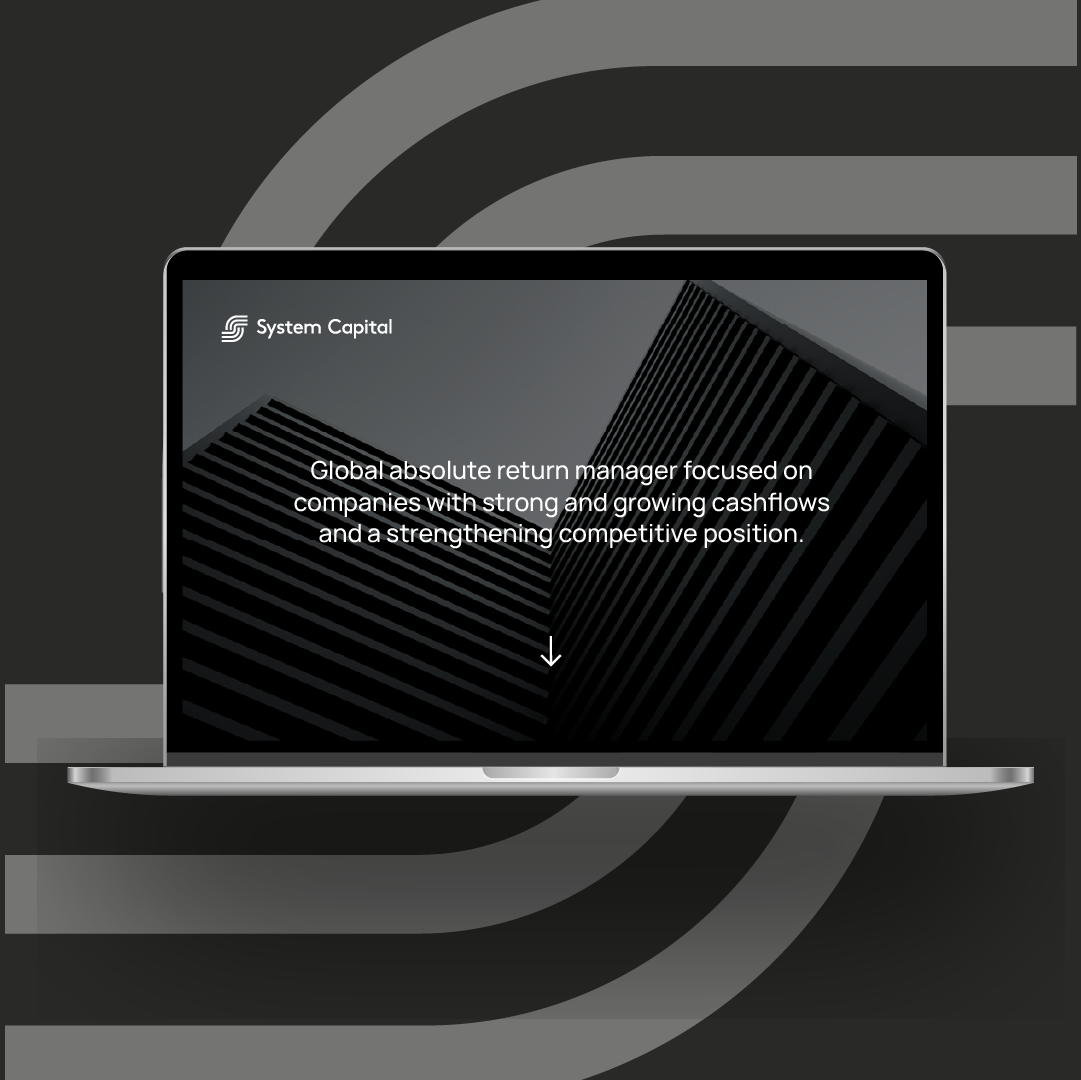 three posters are hanging on a wooden wall with a man sitting at a table .