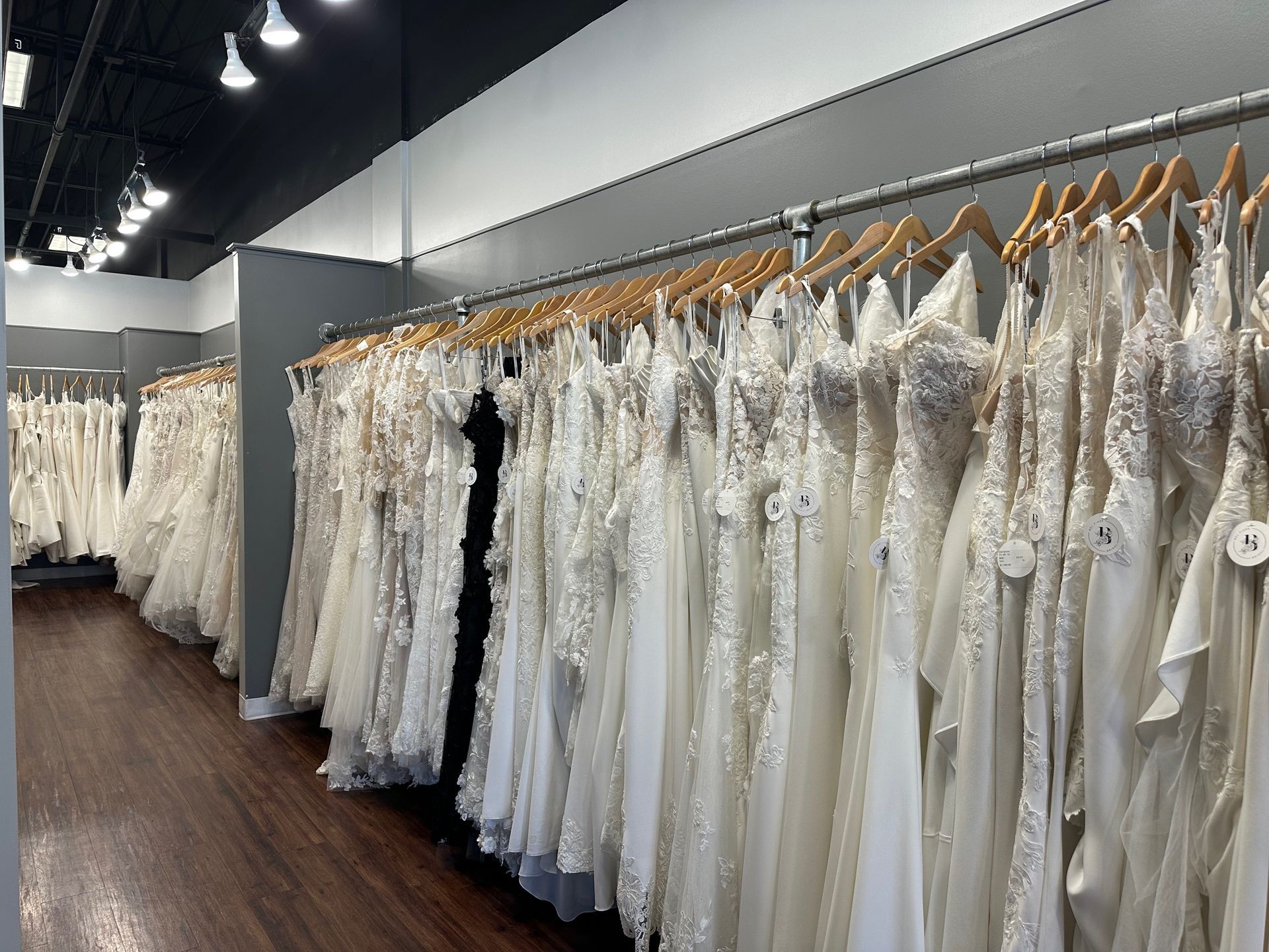 Wedding dresses hanging on racks in a bridal shop.