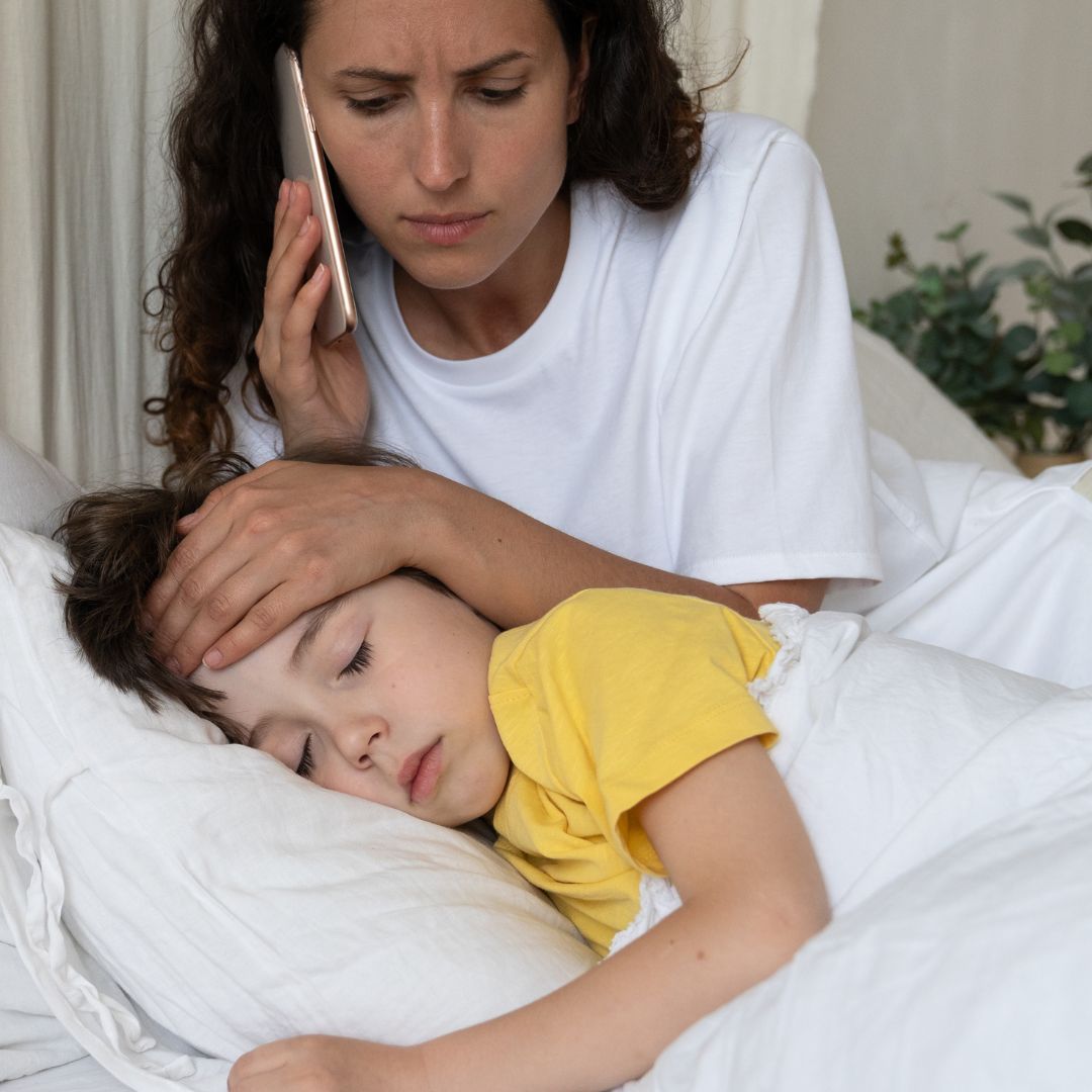 Mom On Phone Caring for Sick Boy