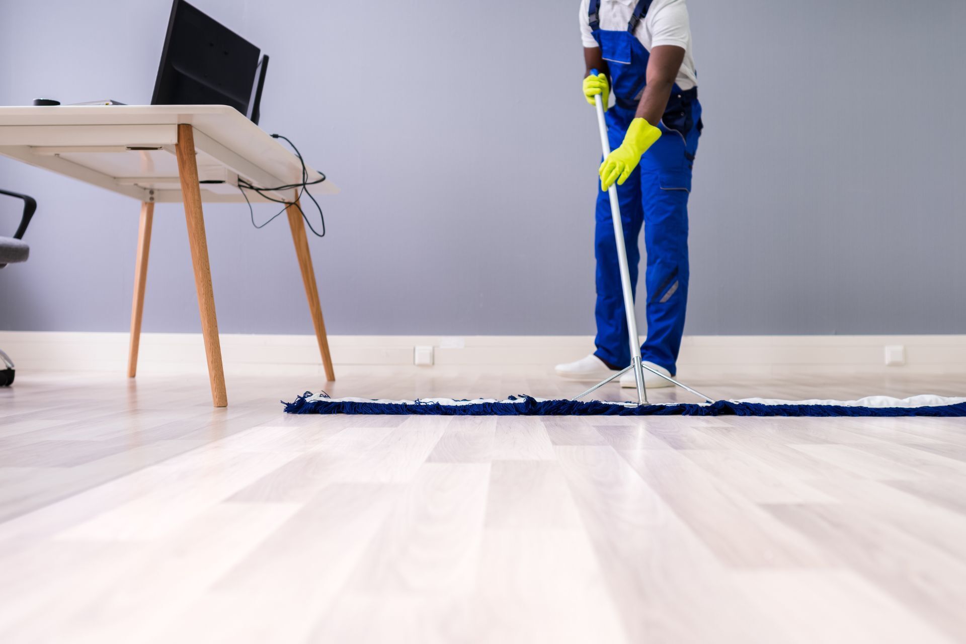 man sweeping the floor
