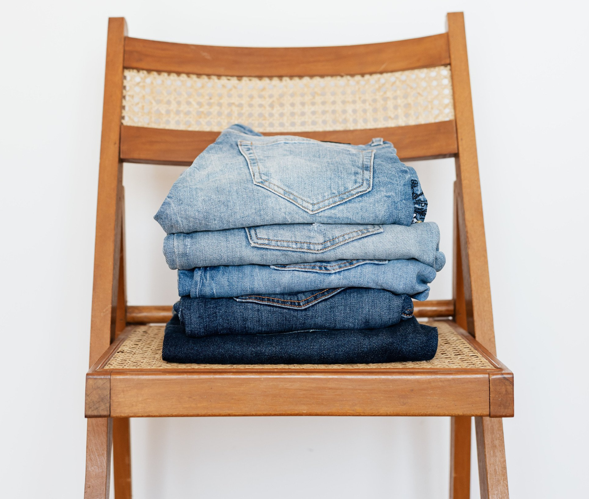 chair with four pairs of jeans on it