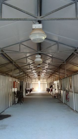 A long hallway with a lot of lights hanging from the ceiling.