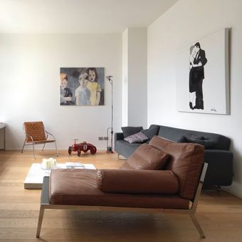 modern living room with large window, wood floor and brown leather sofa