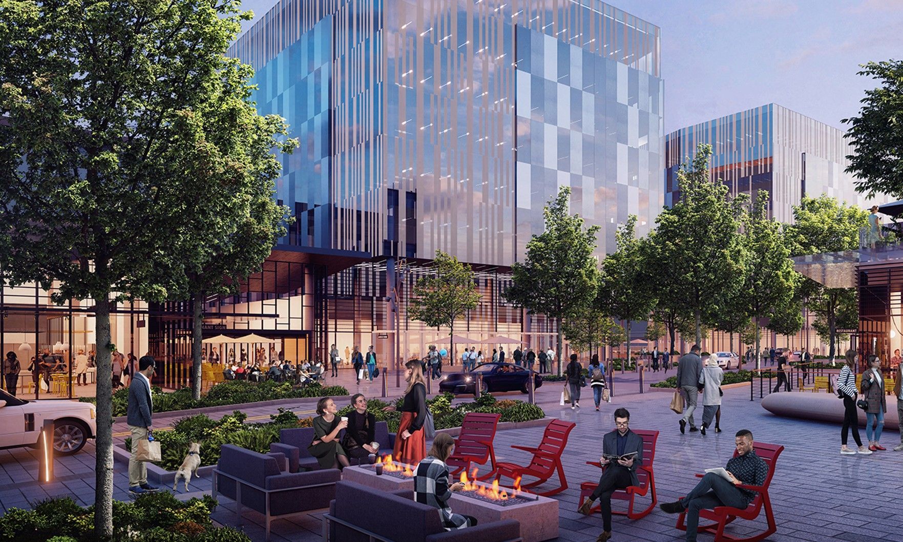 People relaxing in a sunny plaza beside modern glass buildings and trees.