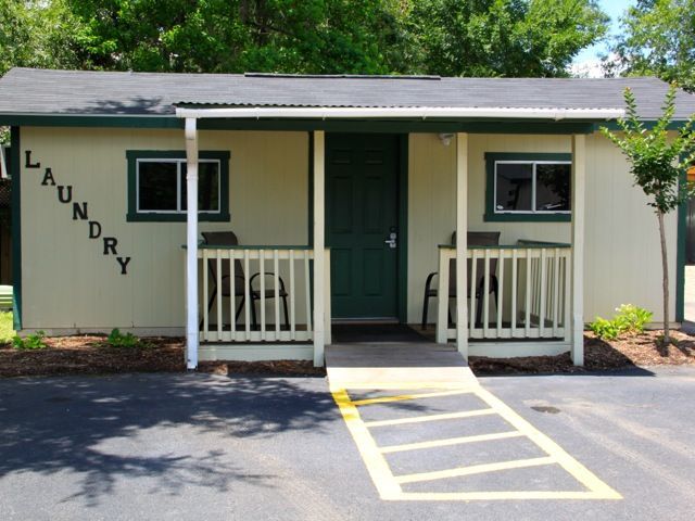 Laundry building with a ramp, green door, and 