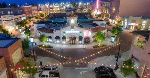Aerial view of a brightly lit town square at night.