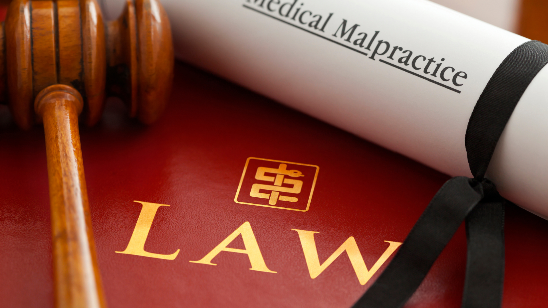 Gavel next to a rolled document titled 