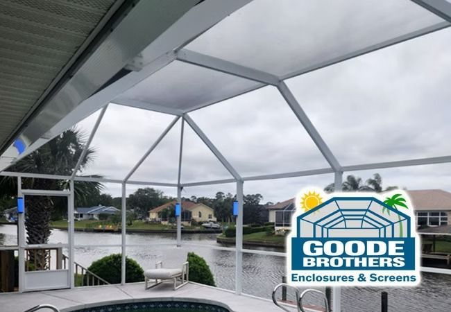A pool enclosure with white framing overlooking a canal, with the Goode Brothers logo in the corner.