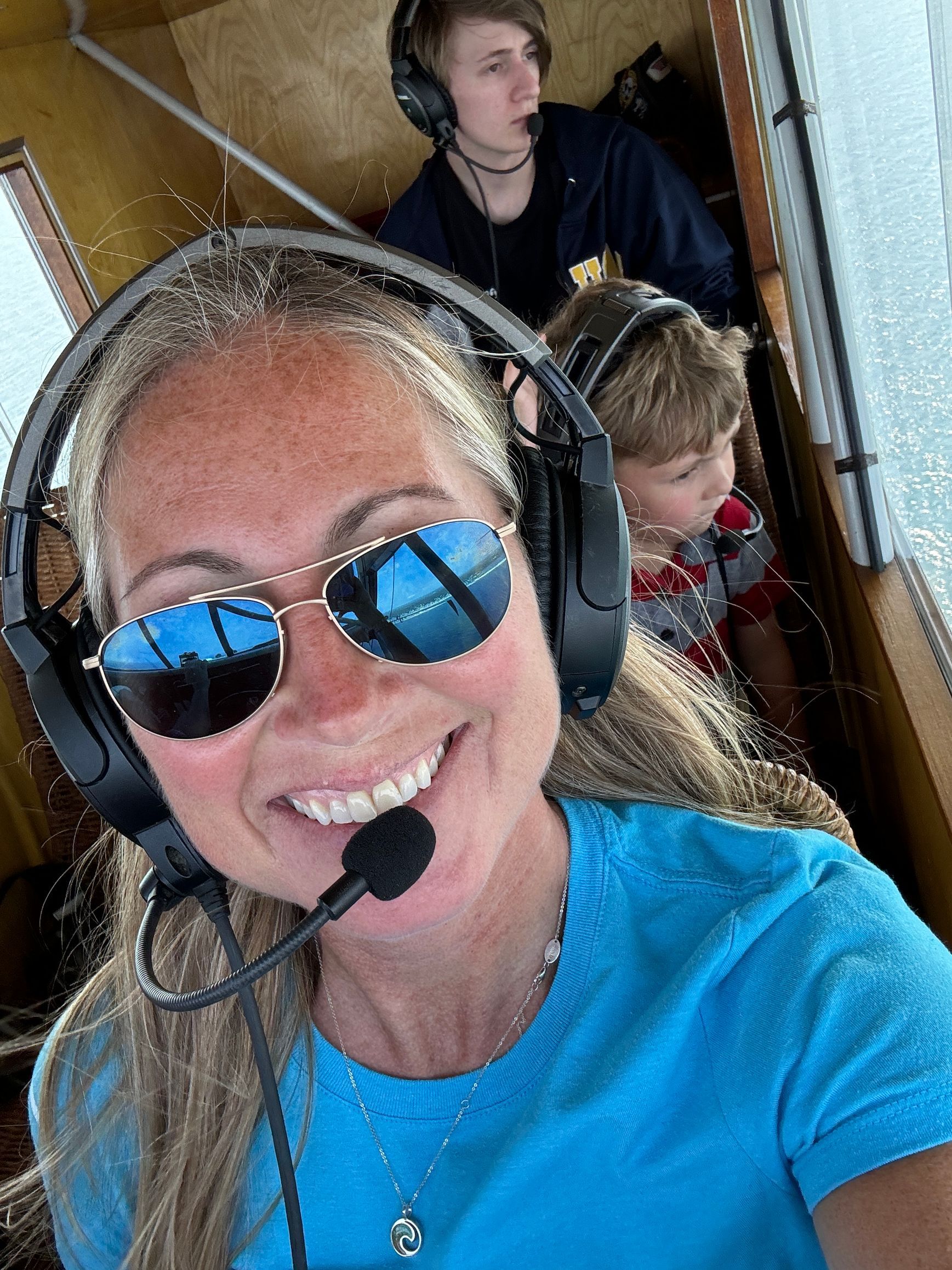 Jessica Power wearing sunglasses and headphones is smiling for the camera.