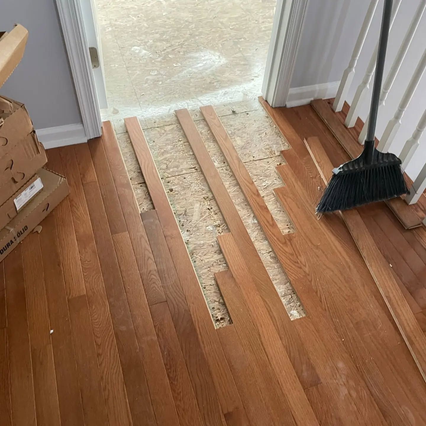 Hardwood floor being installed in a doorway.
