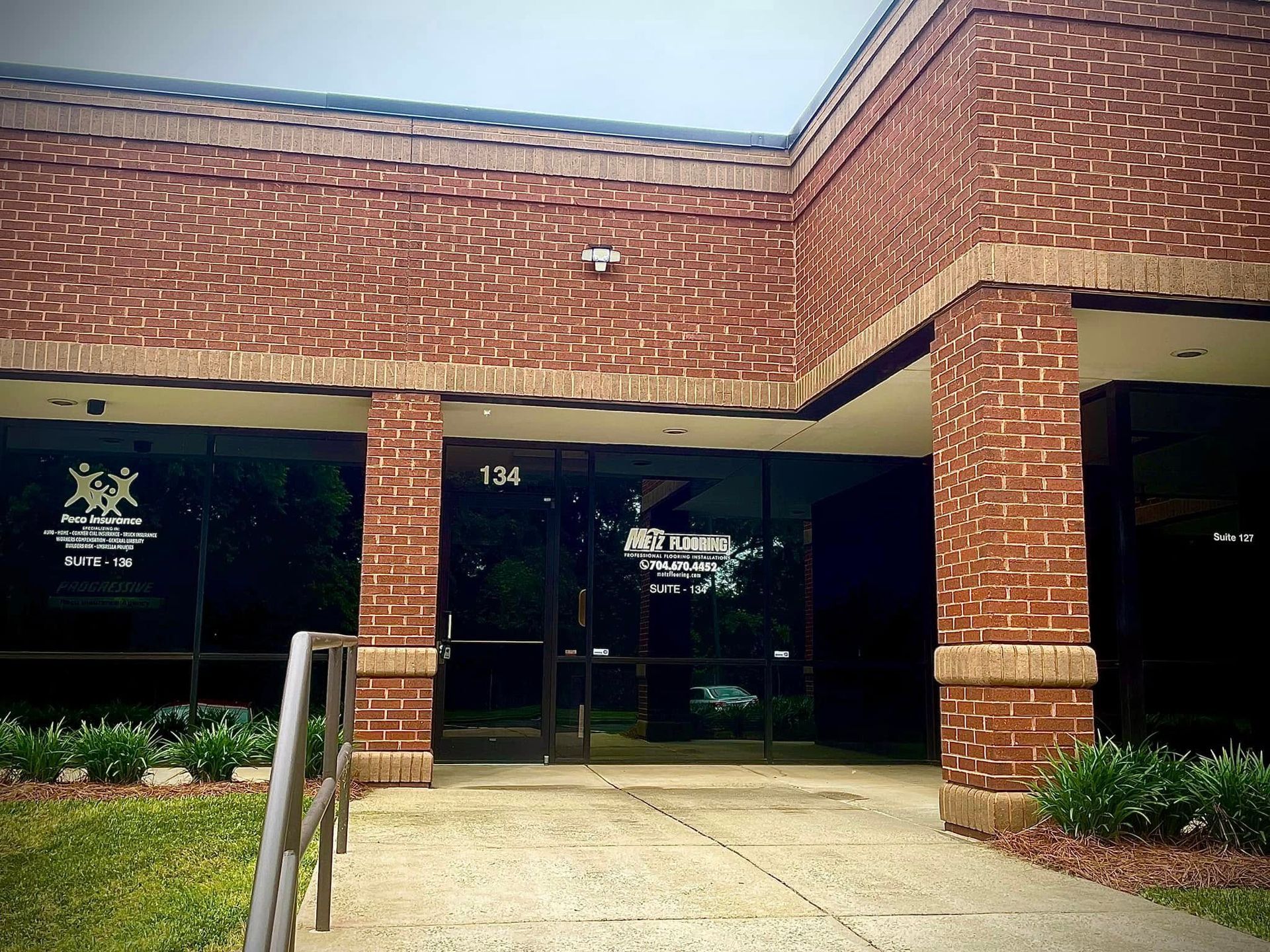 Brick building with glass front entrance.