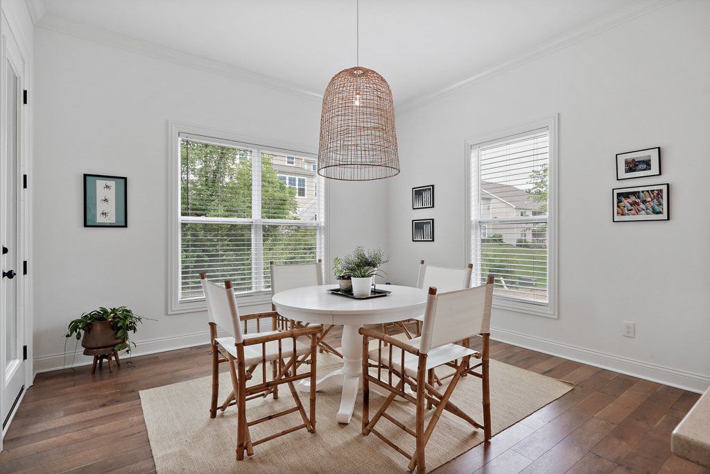 A dining room with a round table and chairs